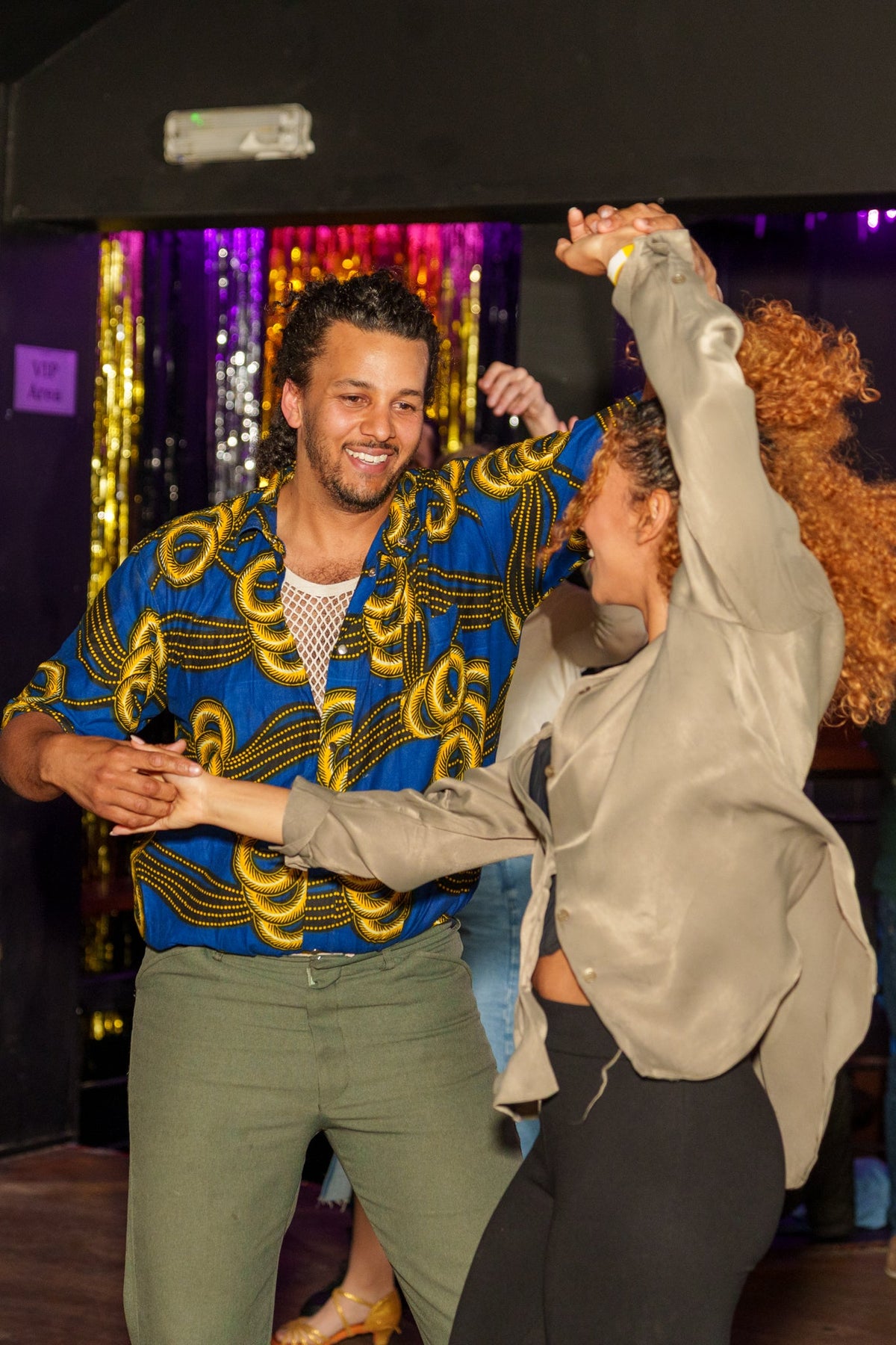 A couple mid-turn on a salsa social night
