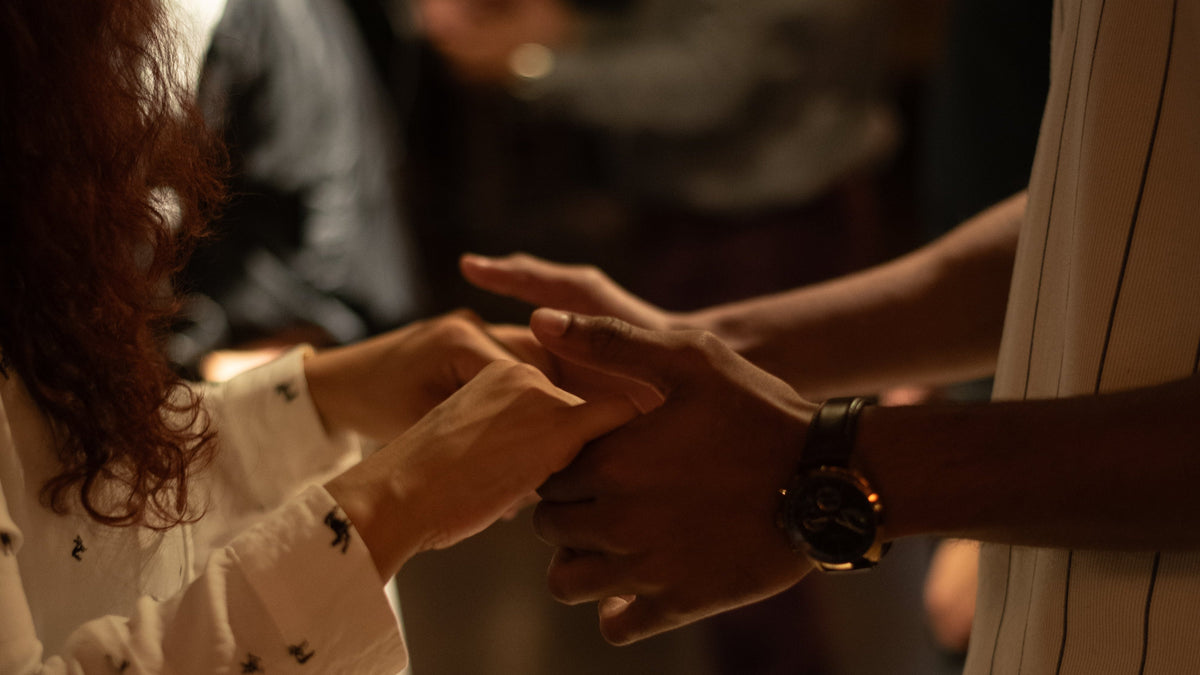 Two dancers joining hands, ready to start a move