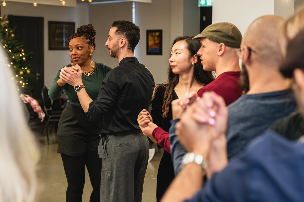 A Christmas salsa party, people dancing in pairs around the room